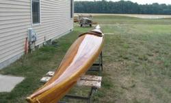 Cedar stripped ocean kayak. This is a Nick Schade designed Guillemot Ocean Kayak. the boat is 18 feet long and has an enlarged cockpit for bigger people. The boat weighs about 38 pounds. she comes with a tractor seat, badk rest, foot pegs, and a double