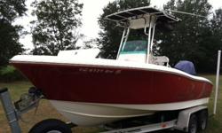 2006 Pioneer 197 Sportfish CC with 2006 Yamaha 150 and 2006 dual axle trailer. Bait Tank / Seat behind center console, large fish box/storage in front, rear seats and headrests in back, cushioned marine cooler in front of center console, depth finder,