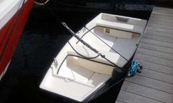 Fiberglass Dinghy w/davits in excellent condition. Great for rowing or towing. Flat prow to keep waves out of boat. Very stable in water. Non-sinkable. Light and easy to carry. Heavy-duty transom mount for outboard motor. Carry handles mounted on transom.