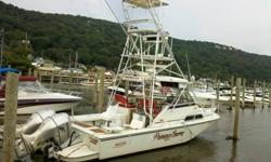 This is a Boston Whaler 27FC with twin Honda 225hp V-Tec 4-stroke outboards. It has a tuna tower with outriggers and upper helm station, an impressive electronics package including EPIRB, and is well equipped for serious offshore fishing in safety and