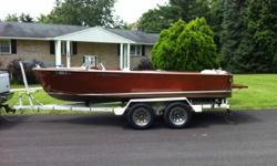 beautiful, classic 1958 Chris Craft Cavalier Utility Runabout sitting on a custom double axle trailer.This is the plywood model (not a kit boat) so you don't have to soak it the beginning of each season to get it ready for the water. Just drop it in, turn