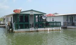 Floating houseboat at Painter Creek Lake Club Pier with large attached floating deck. Screened in porch. Furnished/appliances/gas grill/new water heater/new pexi pipe plumbing system/AC/shower/incinolet toilet system/tin roof. Excellant view of the lake