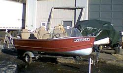 This boat is externally painted red, & the inside is grey. it has a full back rest bench seat in the back, & two bucket seats in the front.
The seats are VERY comfortable; as they came from a car. The trailer is very basic, but fully functional...NEW