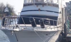 This is a clean and well-maintained motoryacht with all of the comforts of home. She is built on the same hull as a 48' Viking, and features a three stateroom/two head layout. Forward is a stateroom with an offset double berth. Moving aft, is a head